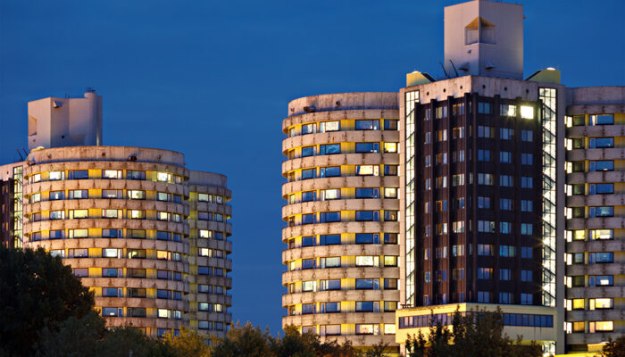 Two tall tower buildings of the Muenster University Clinic hospital at night, Germany.